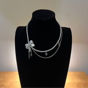 Elegant Pearl Necklace with Bow and Charms